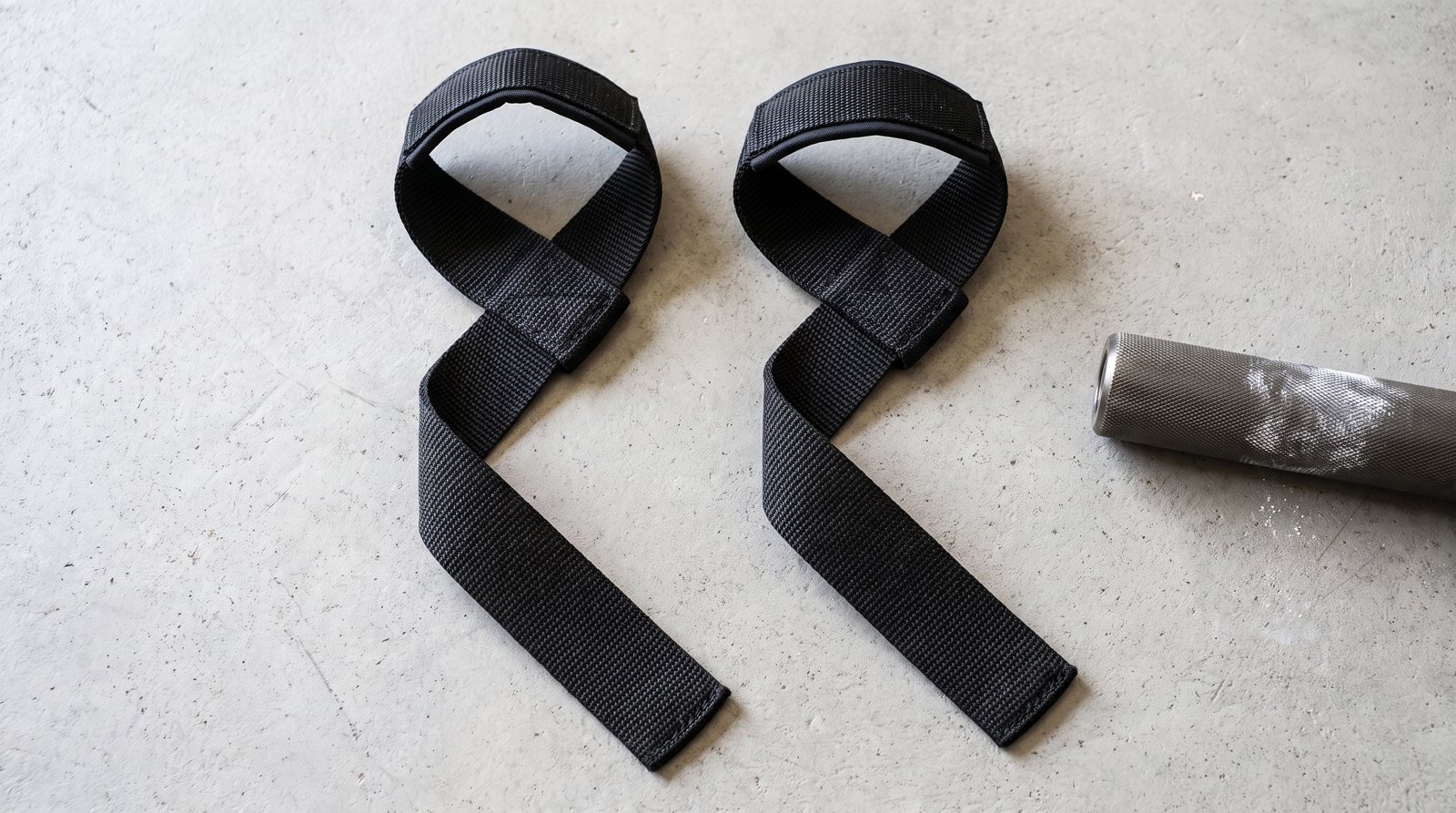 Two woven lifting straps with their loops and long tails visible.