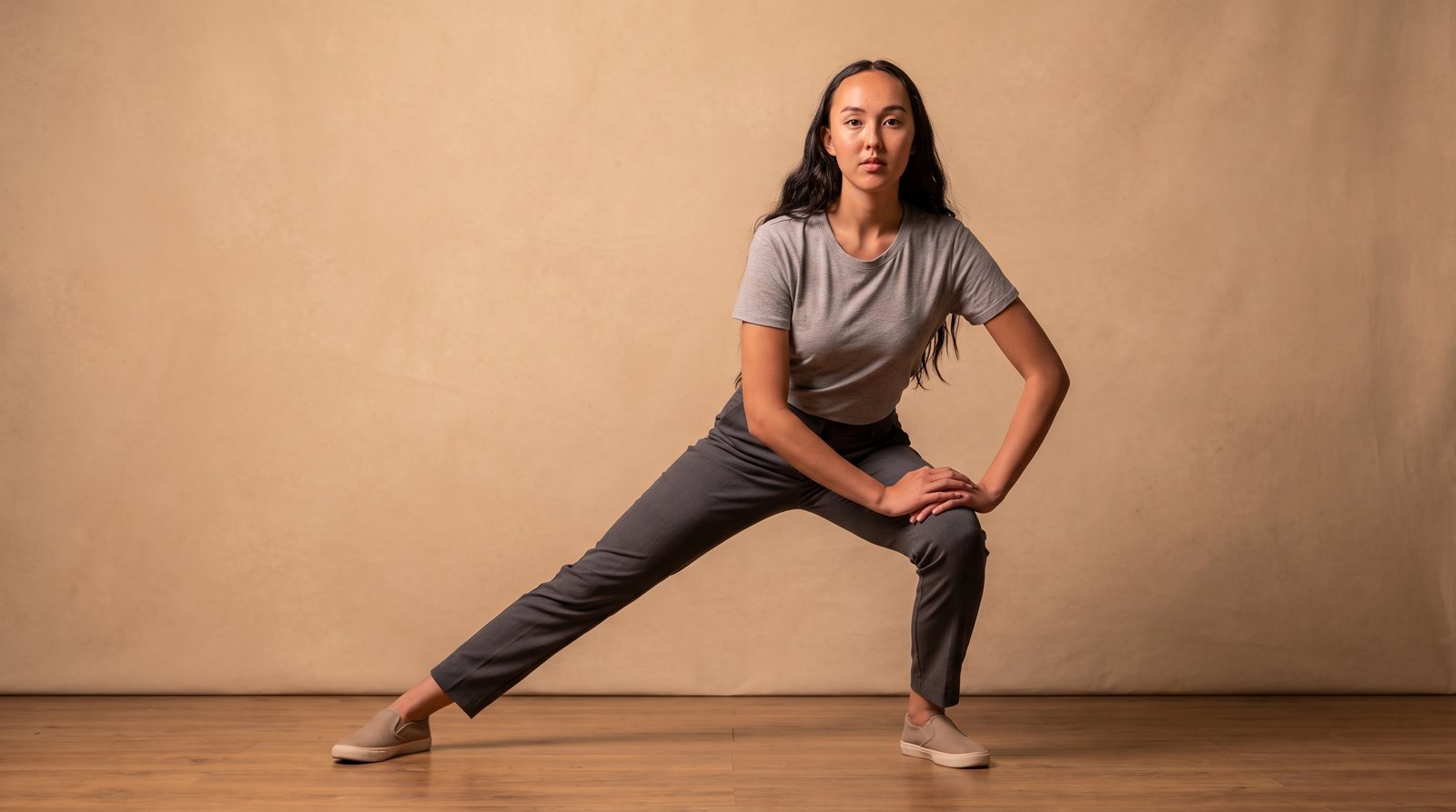 A controlled side-lunge position on an uncluttered exercise floor.