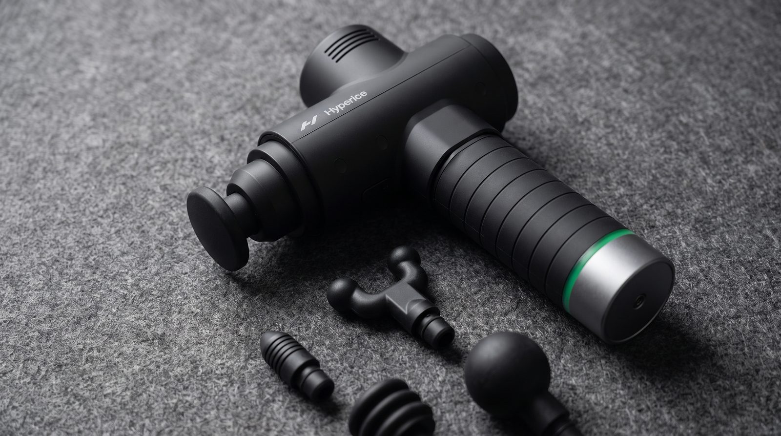 The referenced Hypervolt 2 Pro with several attachment heads on a felt surface.