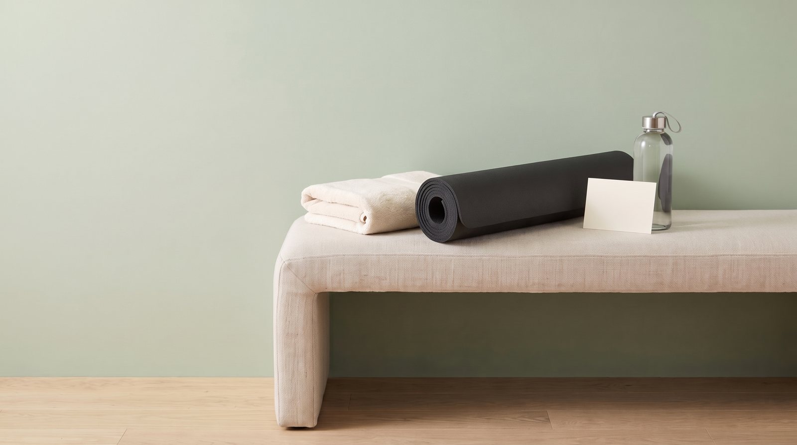 A mat, towel and blank appointment card for exercise planning.