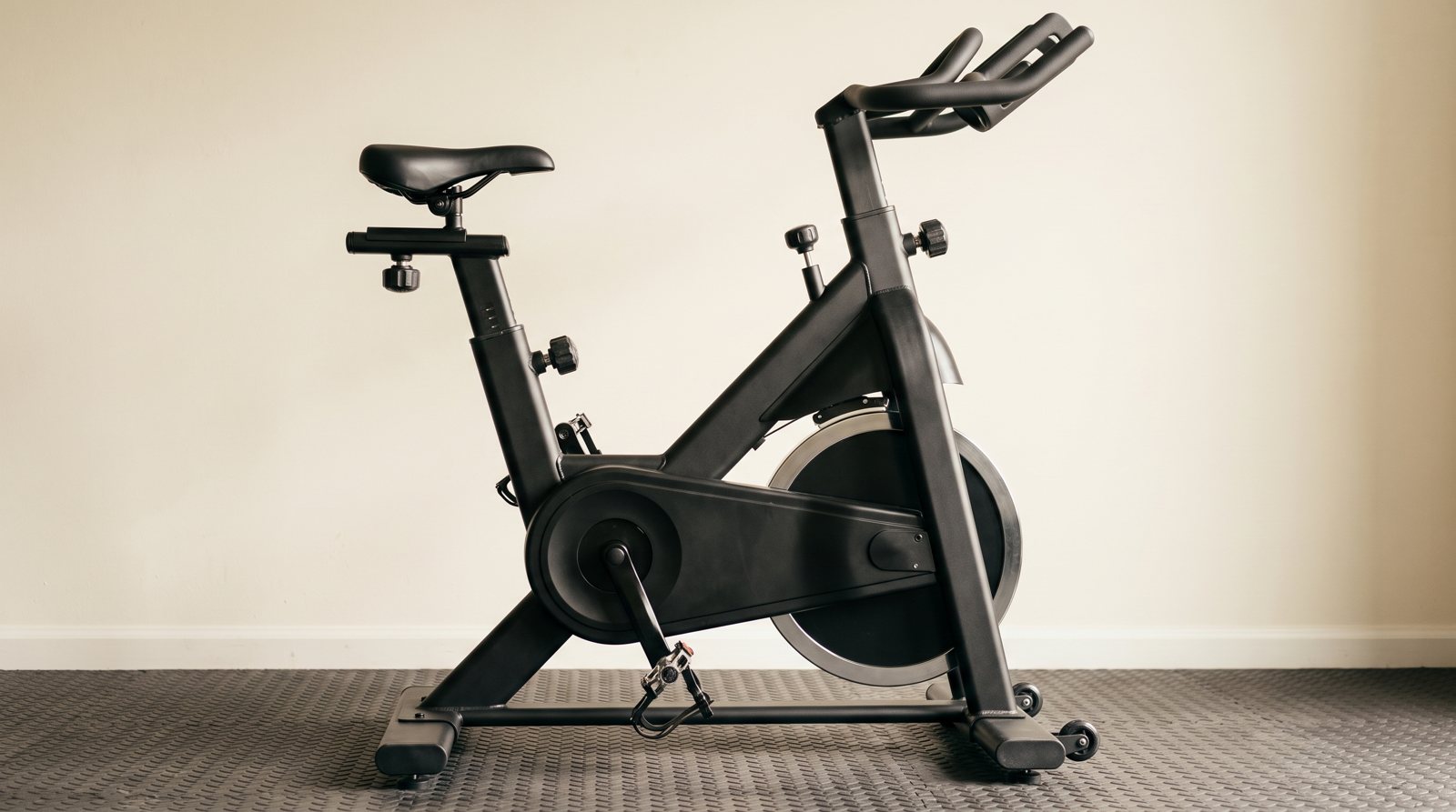 A stationary bike showing its saddle and handlebar adjustment points.